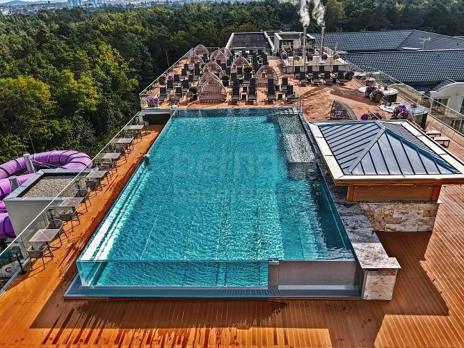 Hotelový střešní bazén s infinity proskleným přelivným žlábkem Hotelový střešní bazén s infinity proskleným přelivným žlábkem